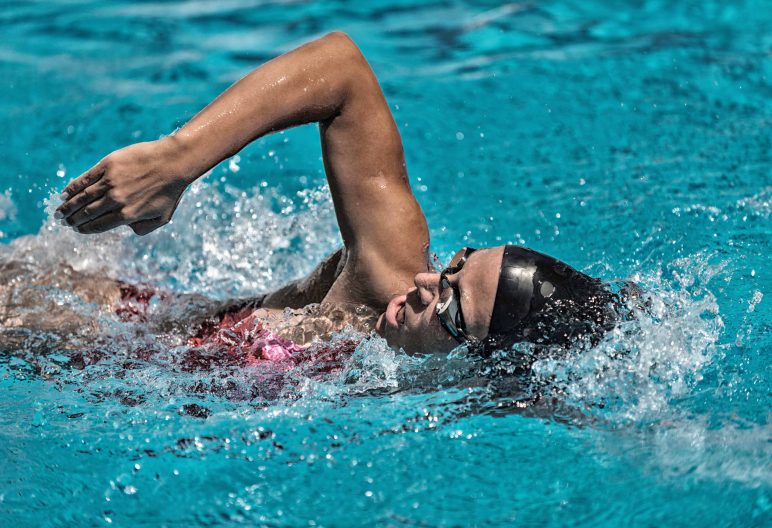 Female swimming front crawl in the pool